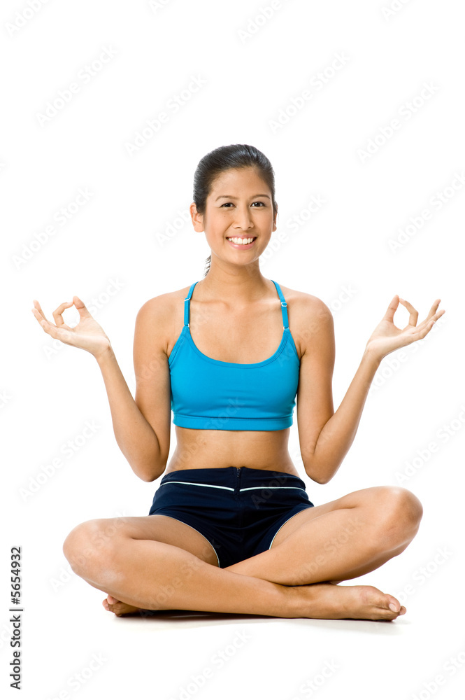A young woman in sportswear sitting on the floor of studio A young woman in sportswear sitting on the floor of studio