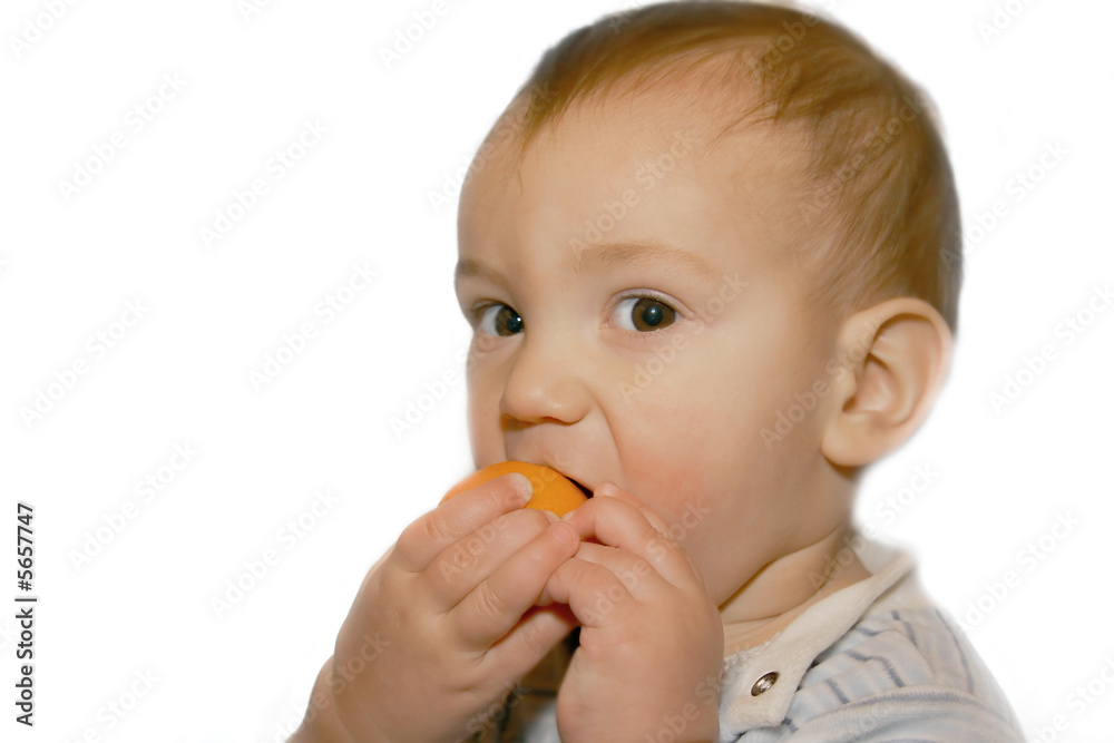 baby boy eatng orange, isolated over white baby boy eatng orange, isolated over white