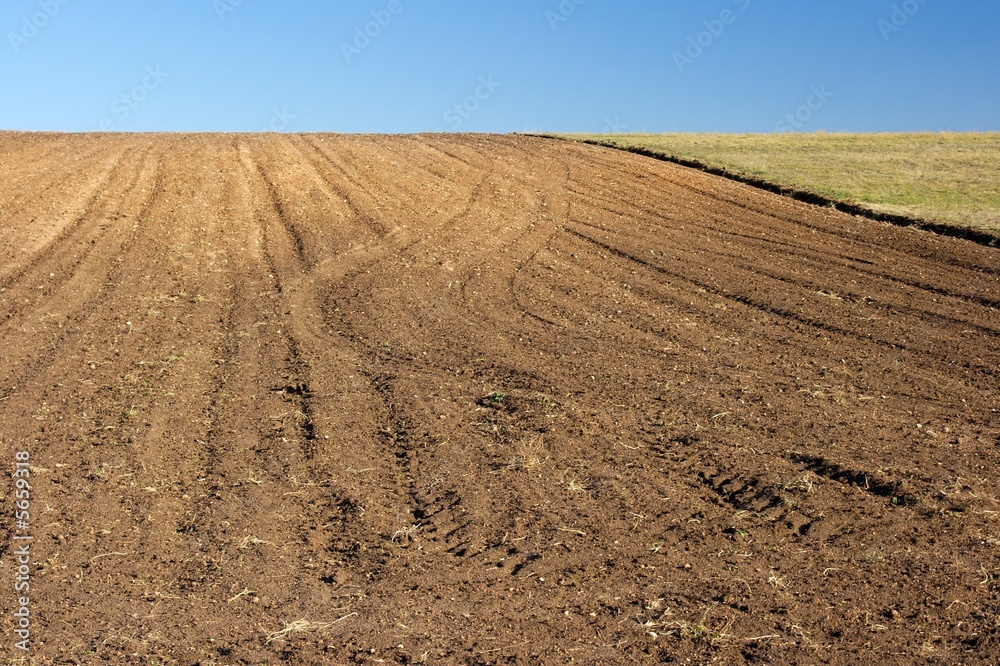 Agricultural field on a hill with brown soil