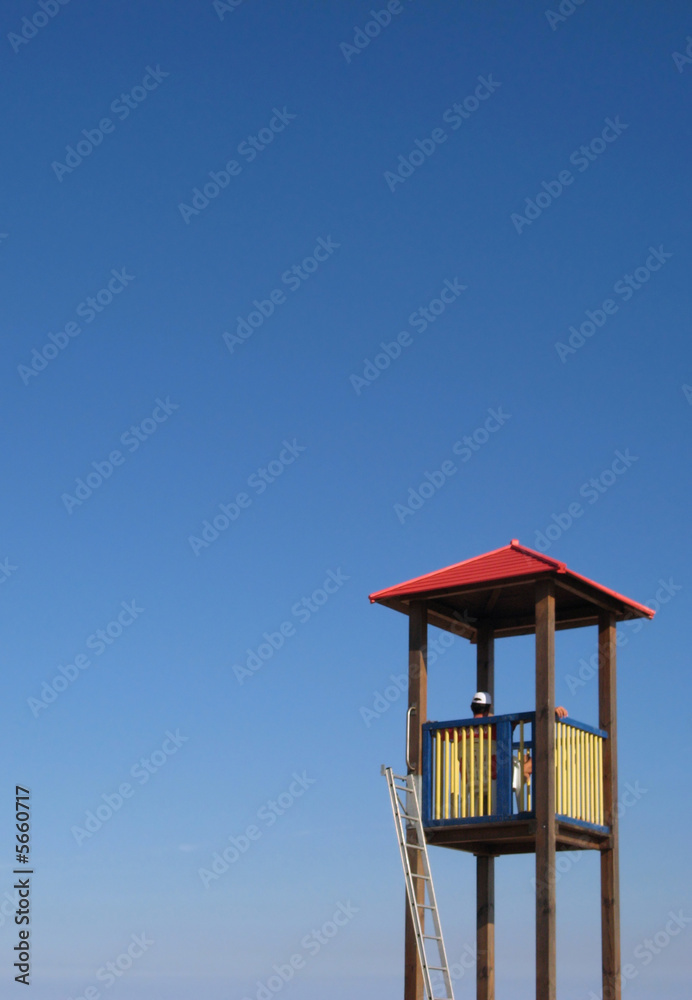 Lifeguard Tower on blue sky. Copyspace on left and top Lifeguard Tower on blue sky. Copyspace on left and top