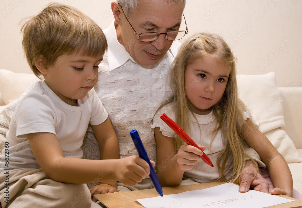 Grandpa is teaching his grandchildren to write Grandpa is teaching his grandchildren to write