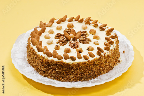 cake with almonds and nut on the yellow plate photo