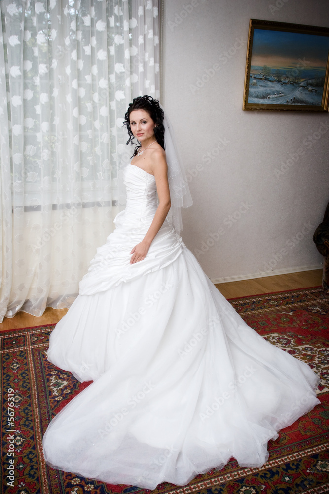 Fototapeta premium a beatiful bride by the window
