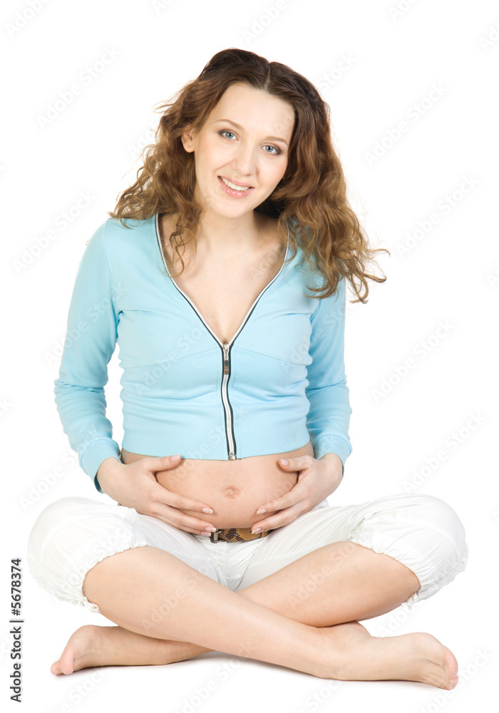 Pregnant women sitting at lotos pose. Isolate on white Pregnant women sitting at lotos pose. Isolate on white