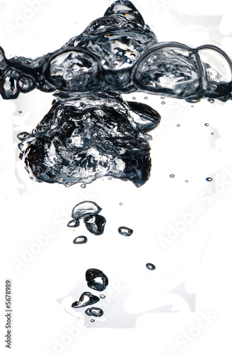 Air bubbles rising in water on white background