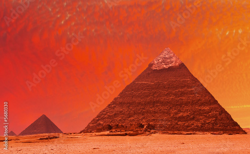 Ancient egyptian pyramids at red sunset
