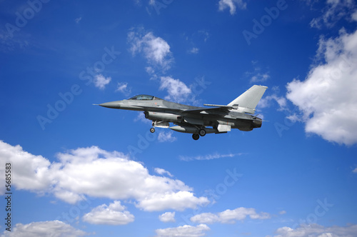 warplane is flying in blu and cloudy sky