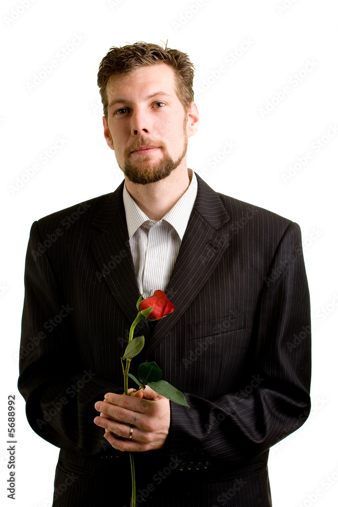 A young man with a single red rose. A young man with a single red rose.