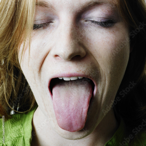 Картината върху платно Woman sticking out her tongue
