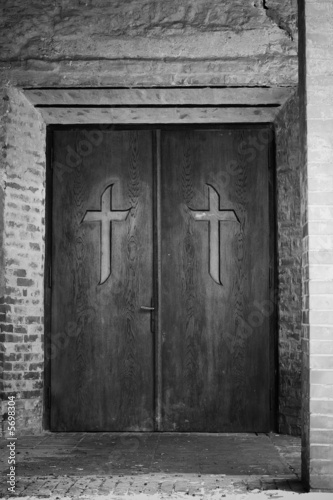 Photo Religion concept - cross on spooky church door