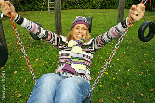 Obraz na plátně happy young woman on a swing