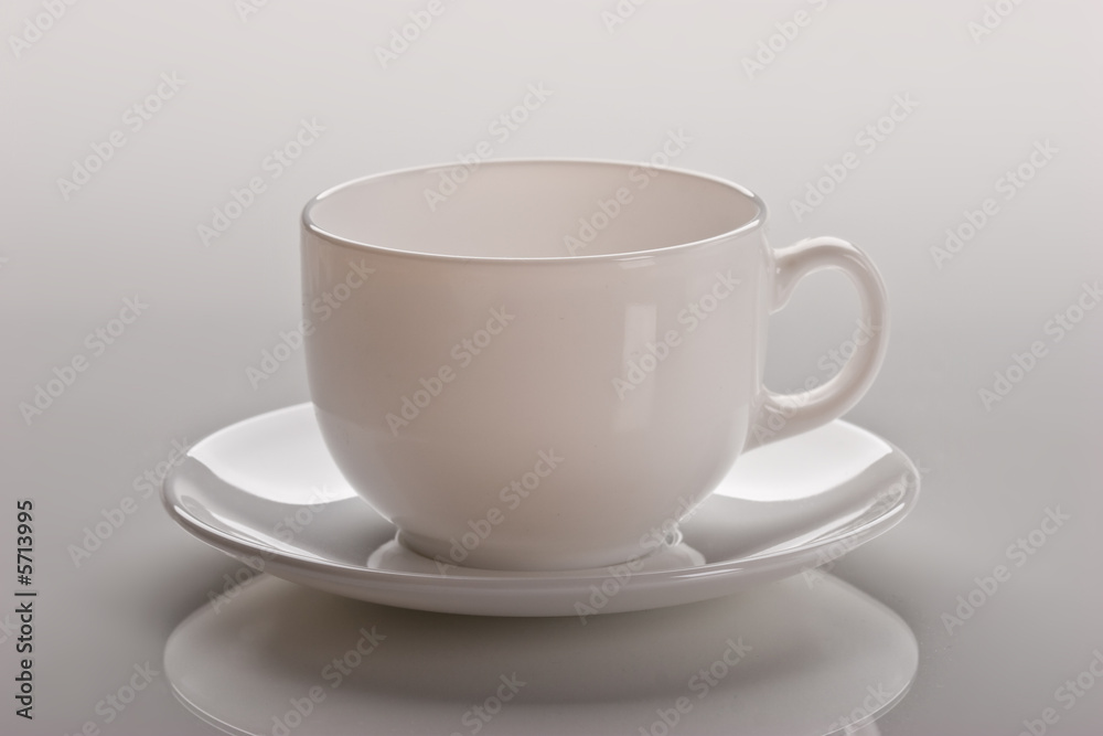 still life, empty white cup over light background still life, empty white cup over light background