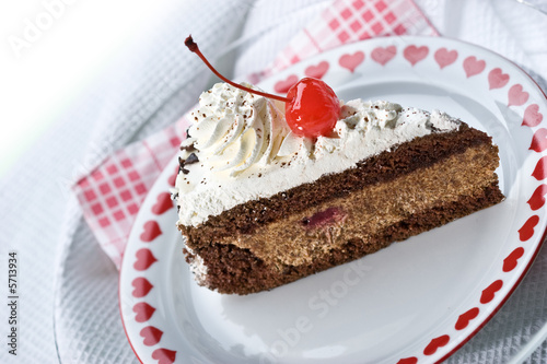 Fotografija Slice of chocolate cake and cherry on the plate