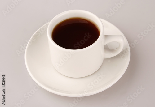 tea in white cup over background