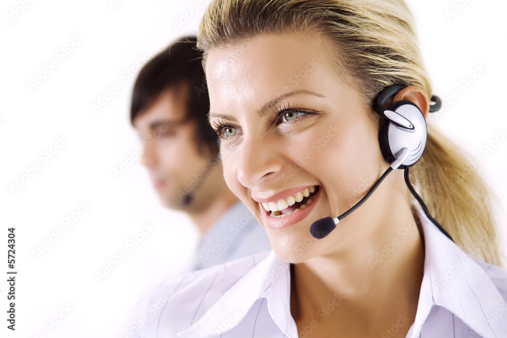 smiling female operator, male working in thebackground smiling female operator, male working in thebackground
