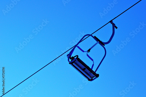 single chair skilift in winter ski resort blue sky