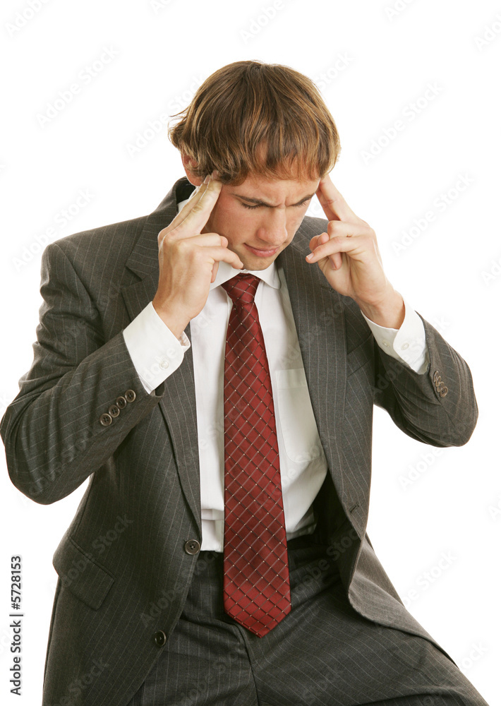 Young businessman stressed out with a headache at work. Young businessman stressed out with a headache at work.