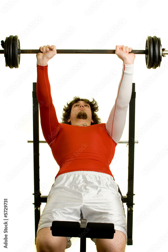Fototapeta premium A young man lifting weights over a white background.