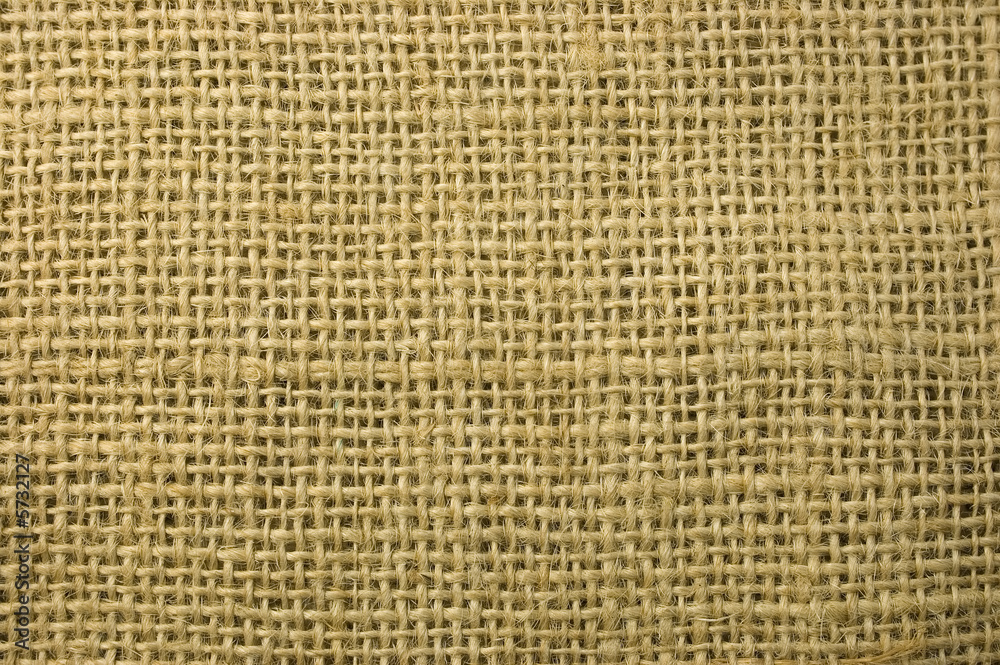 Textured background of a sandy brown burlap cloth Textured background of a sandy brown burlap cloth