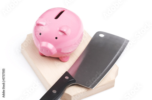 piggy bank and kitchen knife, extreme savings reduction concept