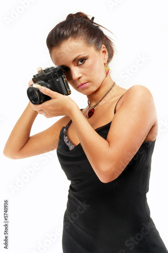 Sexy girl with old photo camera watching you.