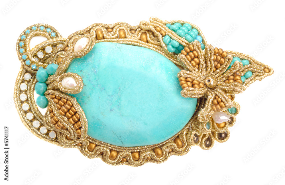 Fototapeta premium Colourful handmade brooch isolated over white background