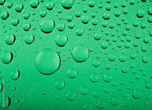 Water drops on green background macro. Shallow DOF..