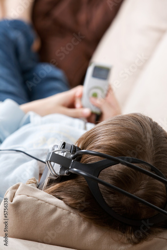 Teenager listening music on the couch