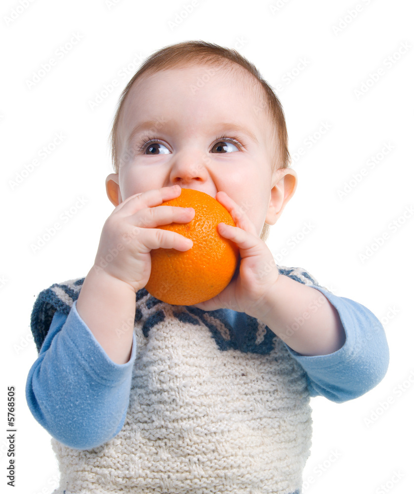 Rustic child eats present orange.The Useful fruit. Vitamins Rustic child eats present orange.The Useful fruit. Vitamins