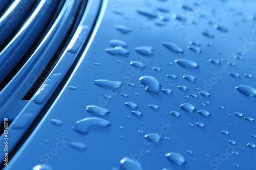 close-up of raindrops on metallic vehicle panel
