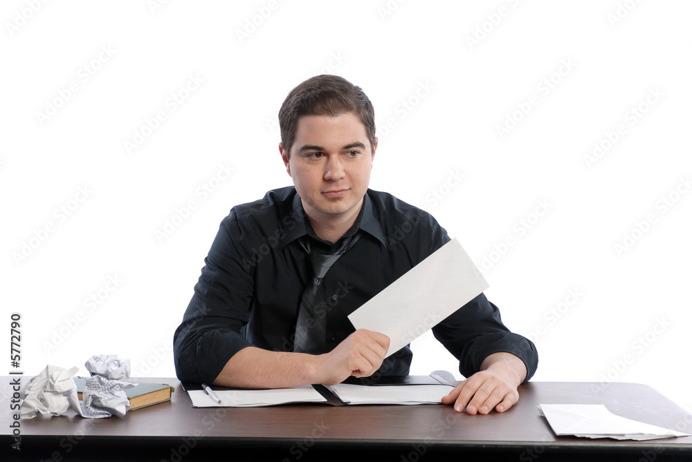 Business man sitting at desk holding blank envelope Business man sitting at desk holding blank envelope