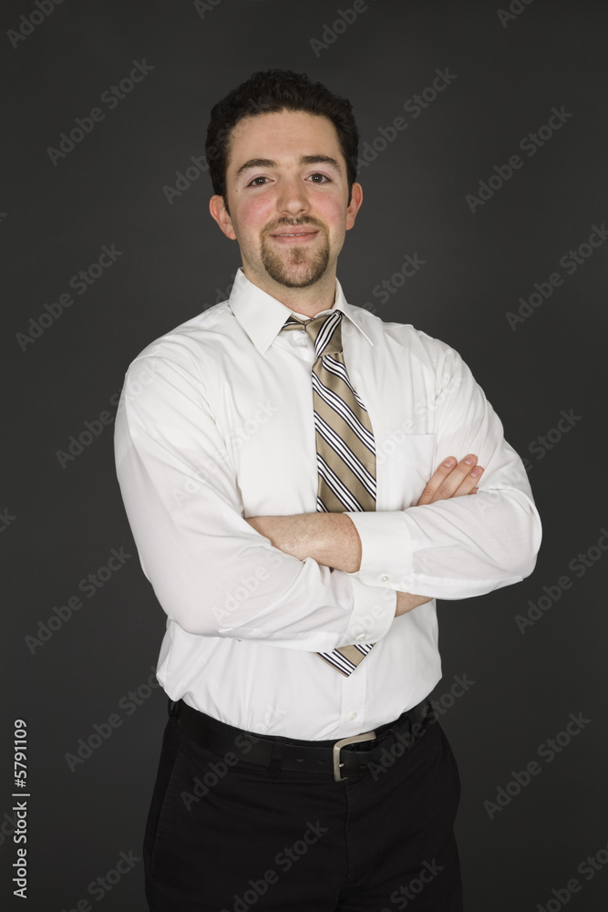 Caucasian businessman standing on gray background Caucasian businessman standing on gray background