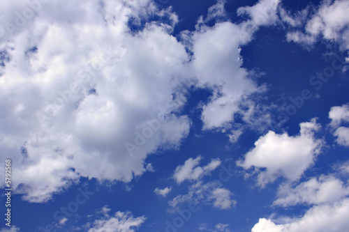 Clouds against a deep blue sky  may be used as background