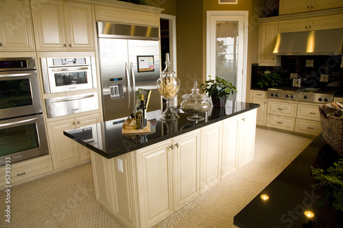 Luxury home kitchen with a granite island.