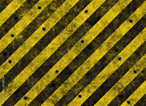 yellow hazard stripes full of bulletholes photo