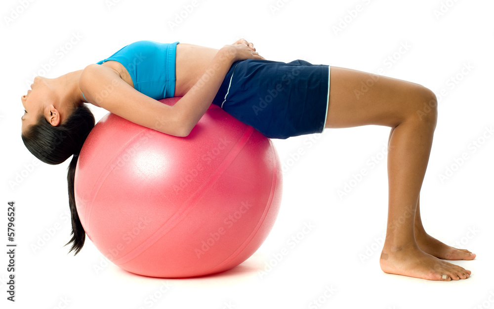A pretty young slim Asian woman exercising with a red fitball A pretty young slim Asian woman exercising with a red fitball