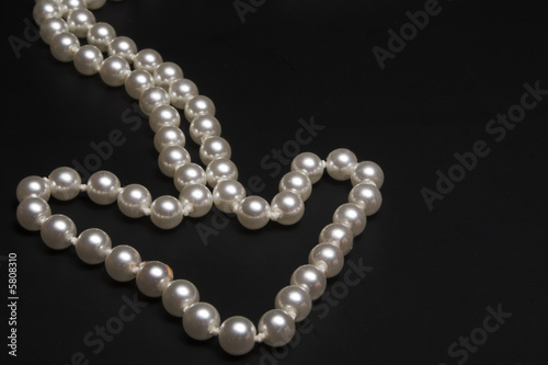 A string of pearls arranged in the shape of an arrow.