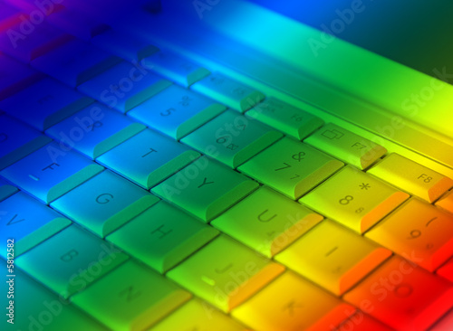 close-up of laptop keyboard overlain with rainbow colors