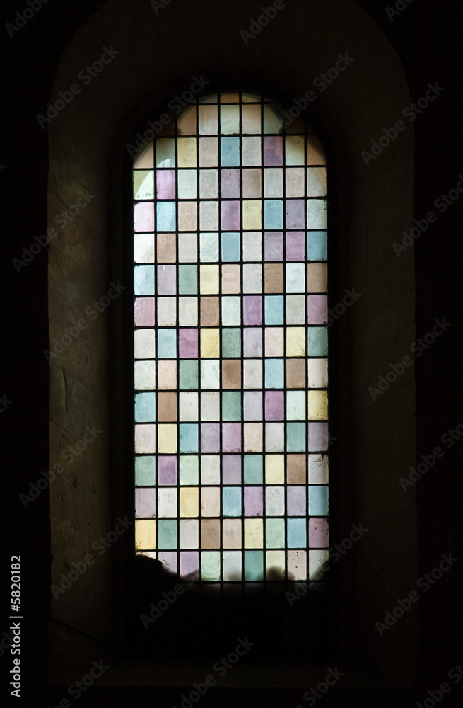 Closeup of medievel, stained glass with pastel colors