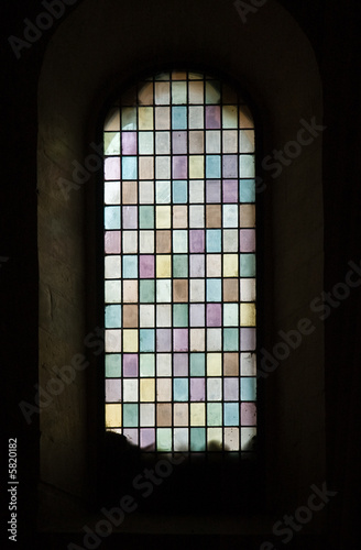 Closeup of medievel  stained glass with pastel colors