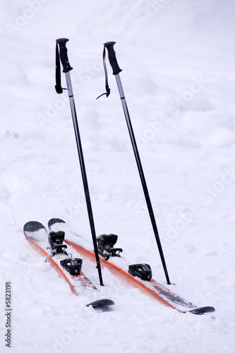 Mountain skies & ski-binding on snow with nobody outdoors