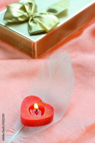 Valentine still-live with candle and present photo