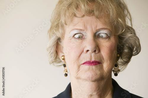 Close-up of a senior woman crossing her eyes.