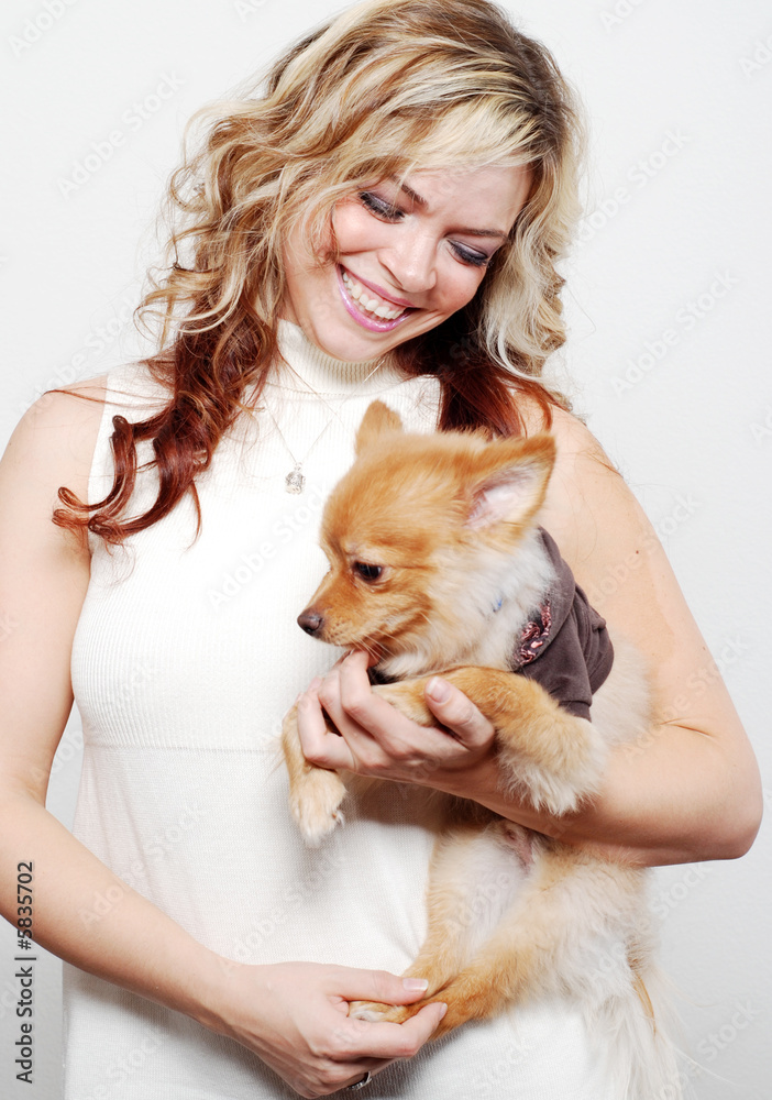 a girl is playing with her cute pet a girl is playing with her cute pet