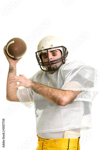 An American football player. Passing the ball.