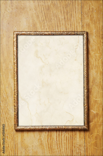 Old photo frame with a stained paper
