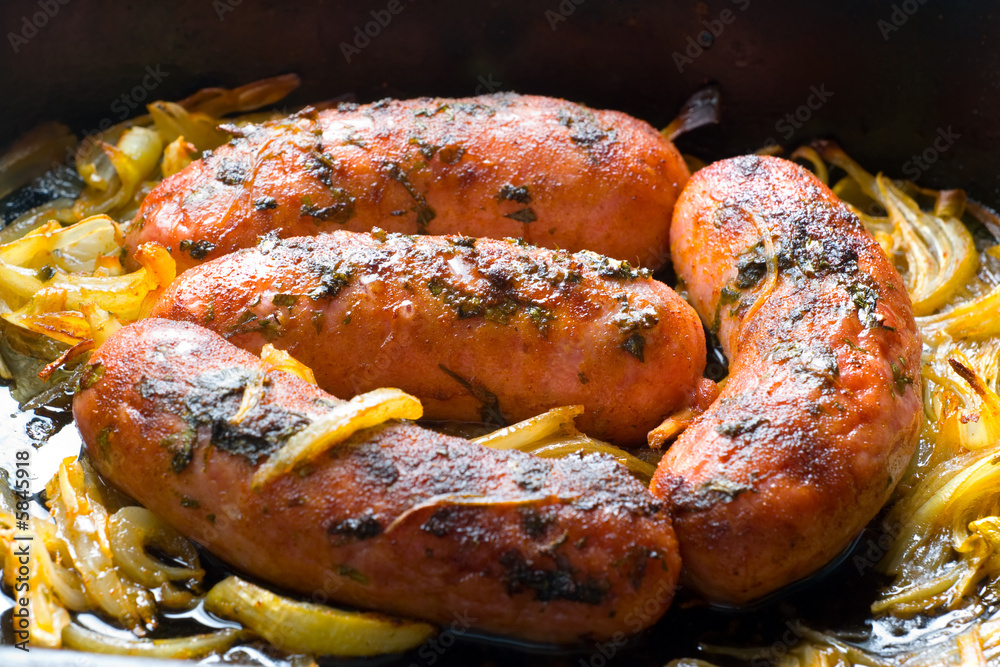Baked pork sausages with onion and spices. Baked pork sausages with onion and spices.