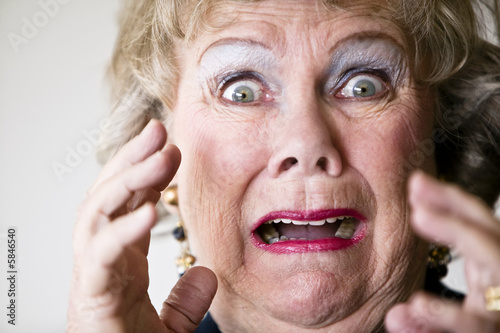 Close-up of a horrified senior woman with her mouth open.