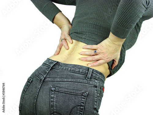 Female with a backache puts her hands on her back