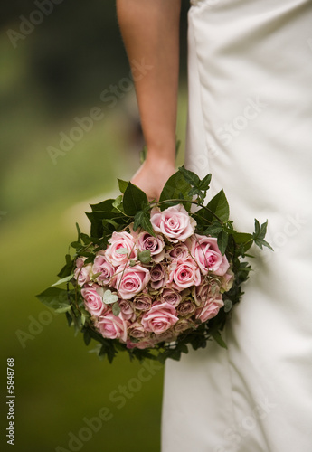 Bride holding bouquet of roses